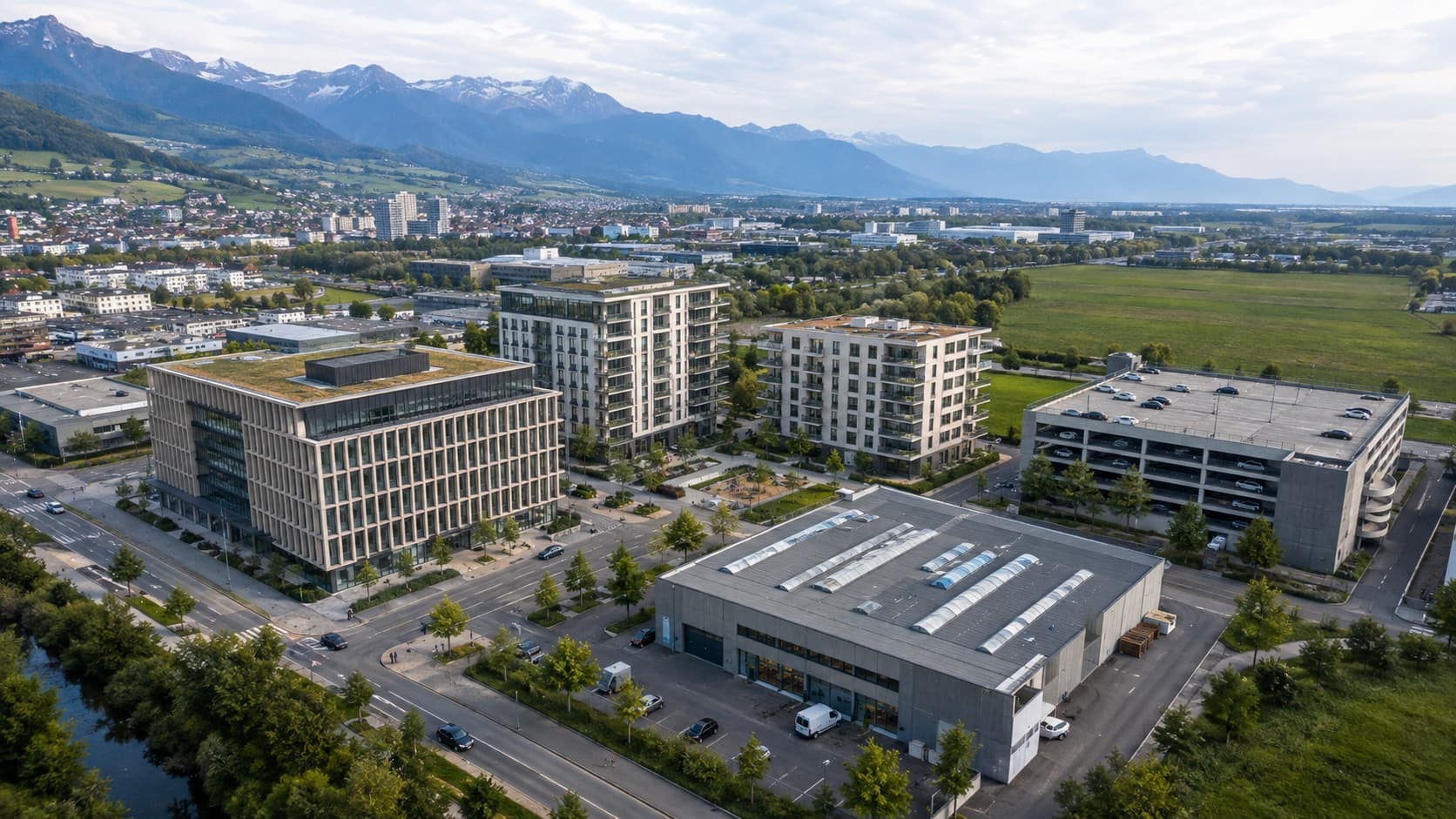 Luftansicht eines Immobilienportfolios mit Wohn-, Büro-, Park- und Gewerbeobjekten